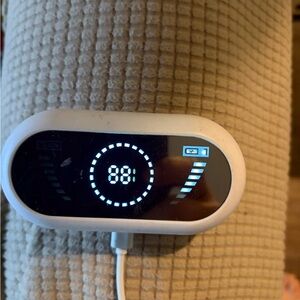 White and Black Digital Display Device - Bluetooth ear buds with charger